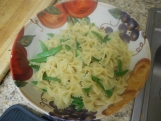 Add the drained pasta, asparagus, and sugar snap peas.